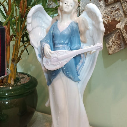 White and Blue Angel With The Musical Instrument